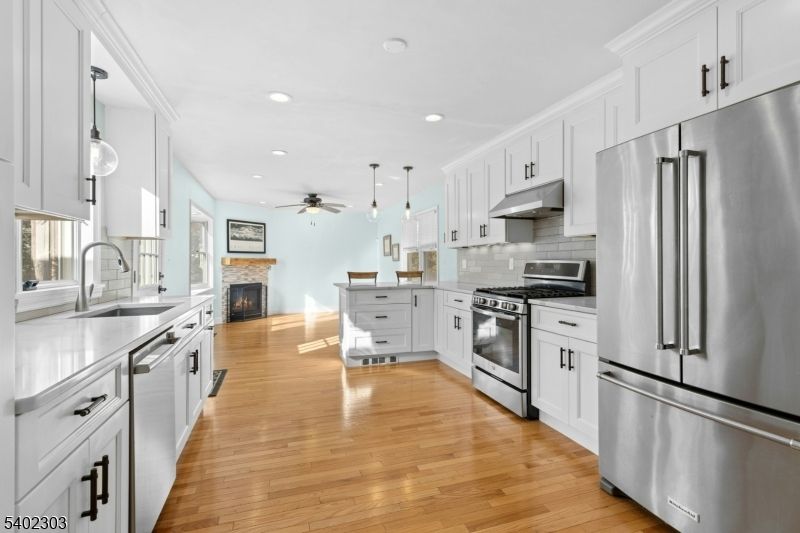 Fireplace, Interior, Kitchen, Pendant Lights, Recessed Lighting, Stainless Steel Appliances, Wood Texture Flooring