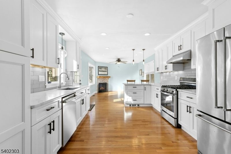 Fireplace, Interior, Kitchen, Pendant Lights, Recessed Lighting, Stainless Steel Appliances, Wood Texture Flooring