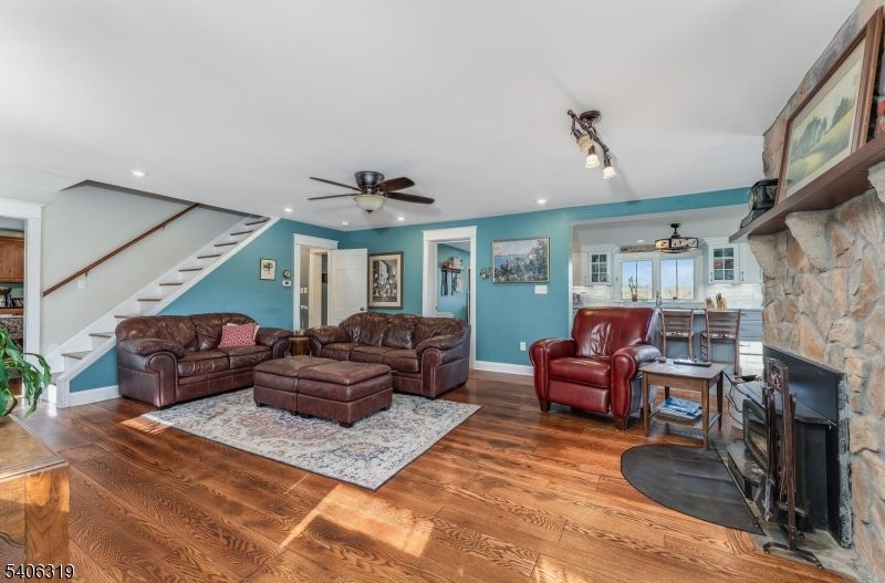 Dining room, Fireplace, Interior, Living room, Recessed Lighting, Stone Walls, Wood Texture Flooring
