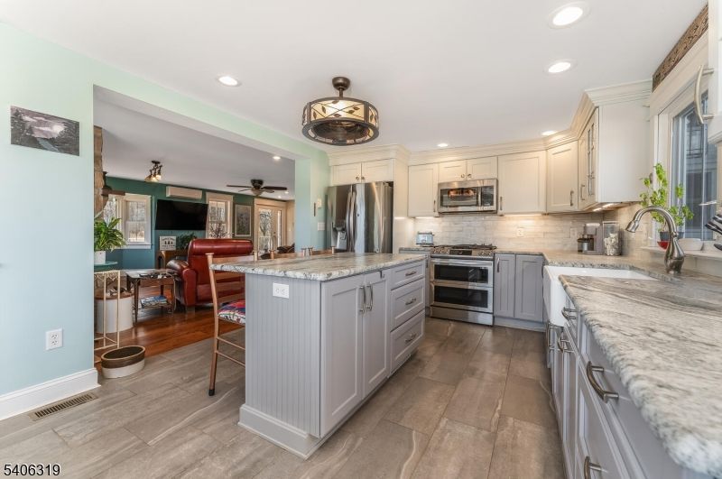 Dining room, Interior, Kitchen, Living room, Recessed Lighting, Stainless Steel Appliances, Wood Texture Flooring