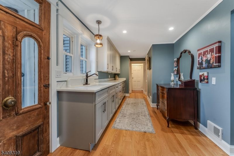 Bathroom, Dual Sink Vanities, Interior, Pendant Lights, Recessed Lighting, Wood Texture Flooring