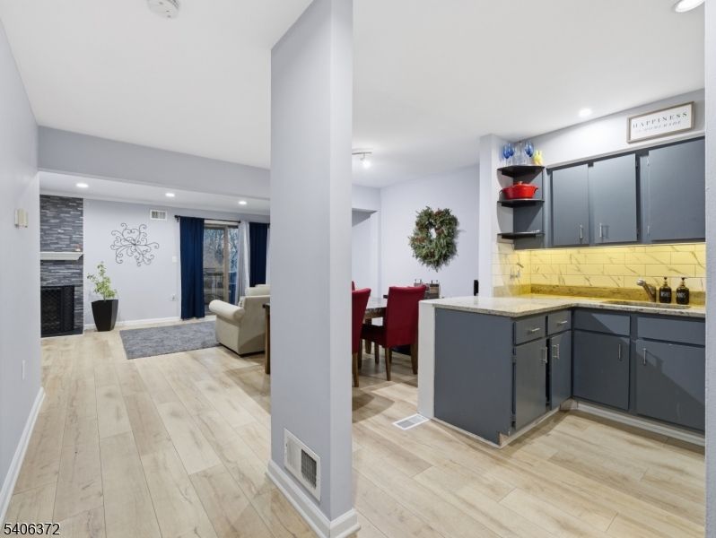 Dining room, Fireplace, Interior, Living room, Recessed Lighting, Wood Texture Flooring