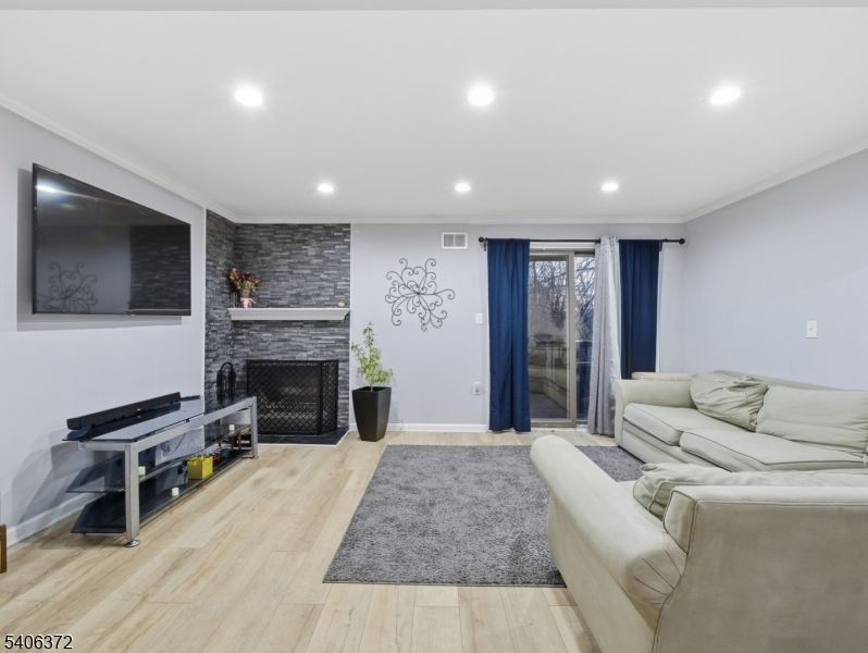 Fireplace, Interior, Living room, Recessed Lighting, Stone Walls, Wood Texture Flooring