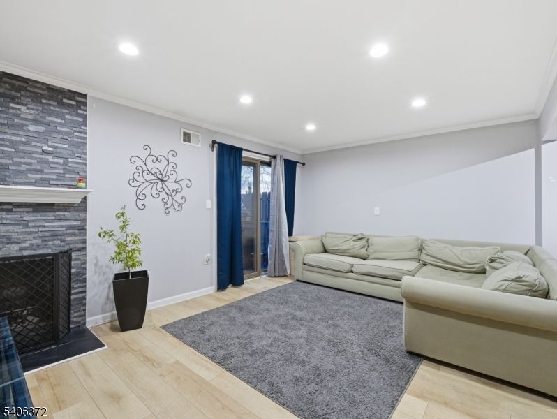 Fireplace, Interior, Living room, Recessed Lighting, Stone Walls, Wood Texture Flooring