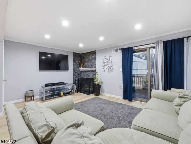 Fireplace, Interior, Living room, Recessed Lighting, Stone Walls, Wood Texture Flooring