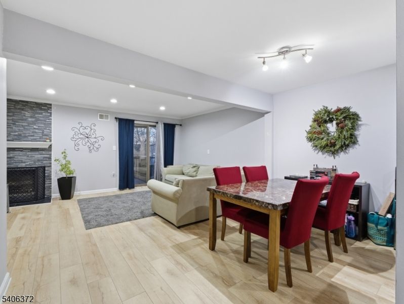 Dining room, Fireplace, Interior, Living room, Recessed Lighting, Wood Texture Flooring