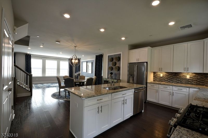 Chandelier, Dining room, Interior, Kitchen, Pendant Lights, Recessed Lighting, Stainless Steel Appliances, Wood Texture Flooring