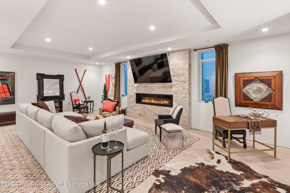 Fireplace, Interior, Living room, Recessed Lighting, Stone Walls, Wood Texture Flooring