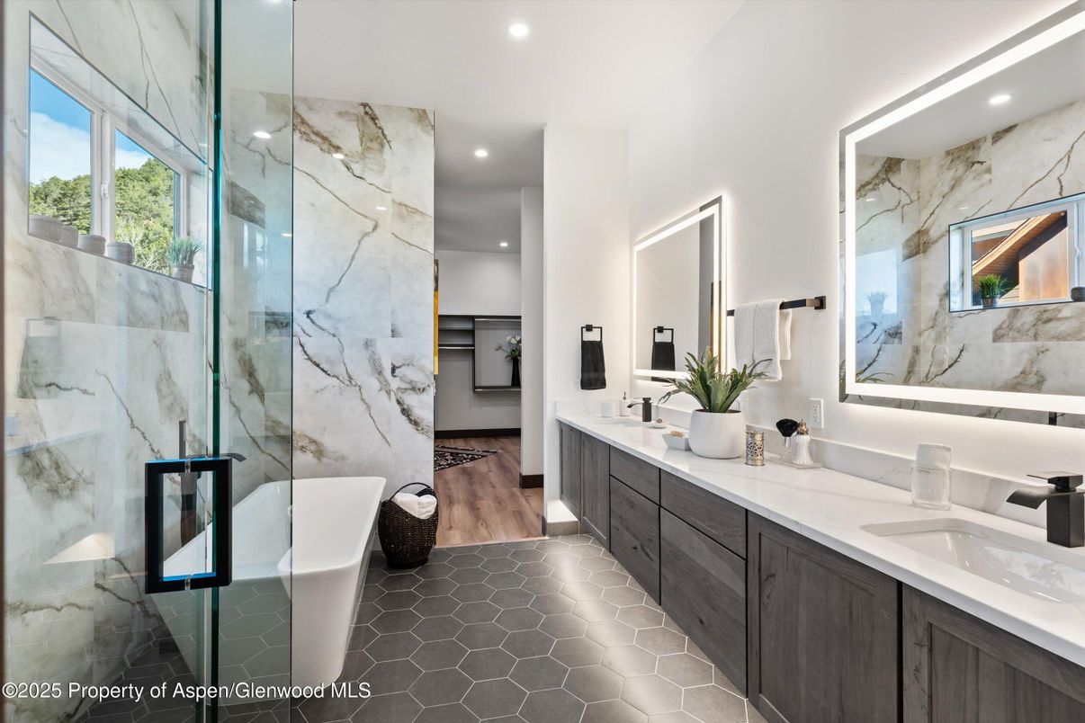 Bathroom, Dual Sink Vanities, Free Standing Baths, Glass Shower, Interior, Marble Walls, Recessed Lighting, Wood Texture Flooring