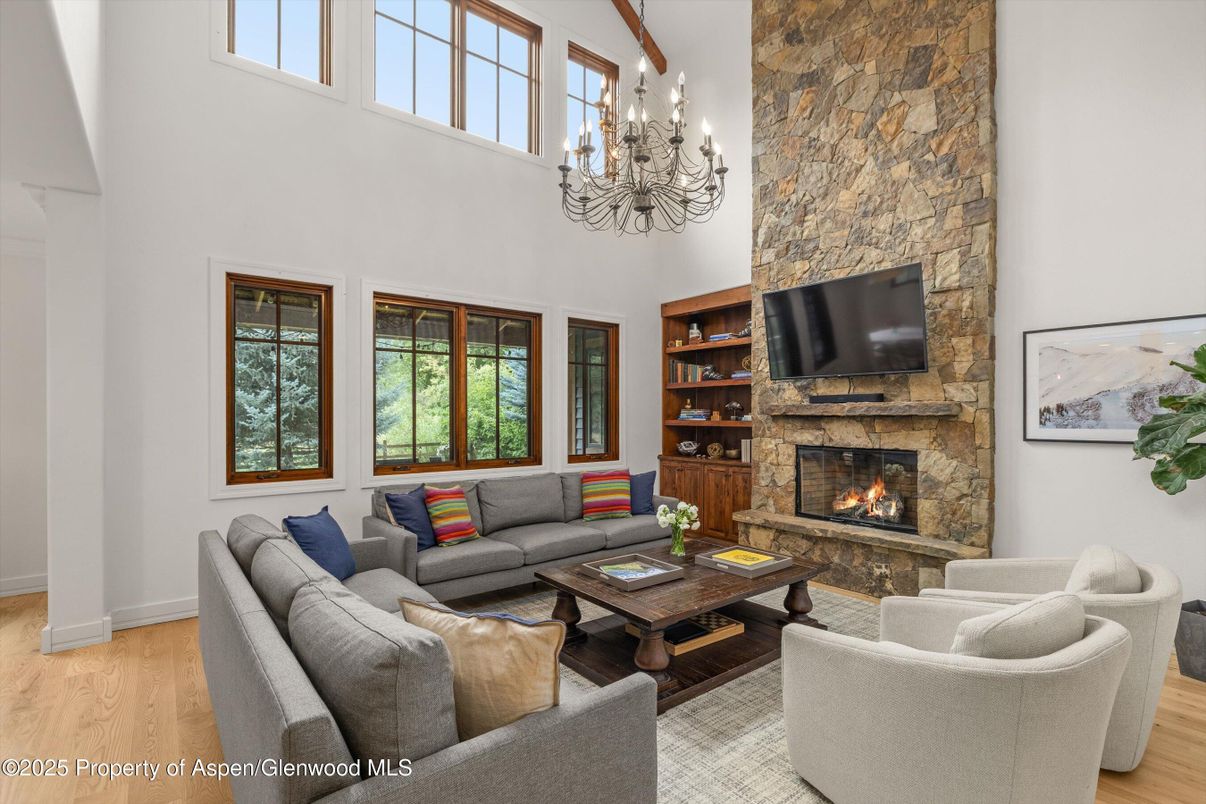 Chandelier, Fireplace, Interior, Living room, Stone Walls, Wood Texture Flooring