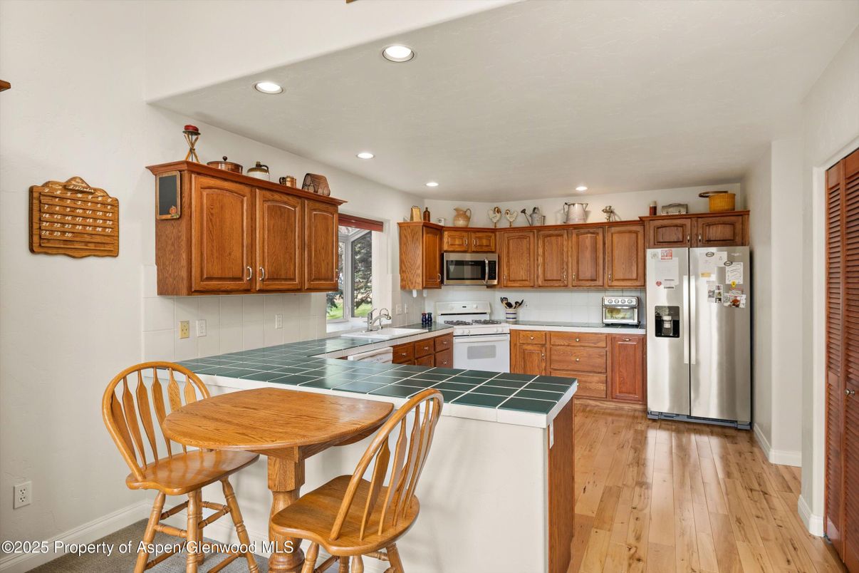Interior, Kitchen, Recessed Lighting, Stainless Steel Appliances, Tile Countertops, Wood Texture Flooring