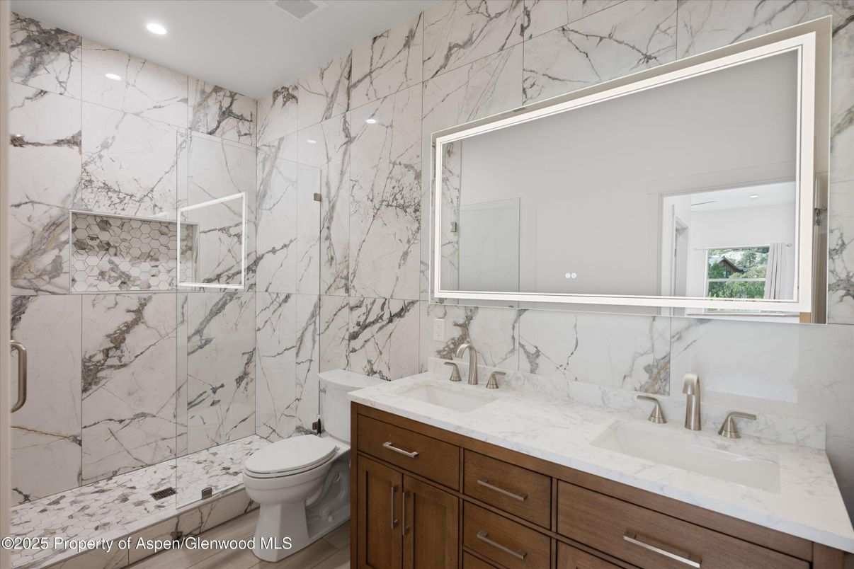 Bathroom, Dual Sink Vanities, Glass Shower, Interior, Marble Walls, Recessed Lighting