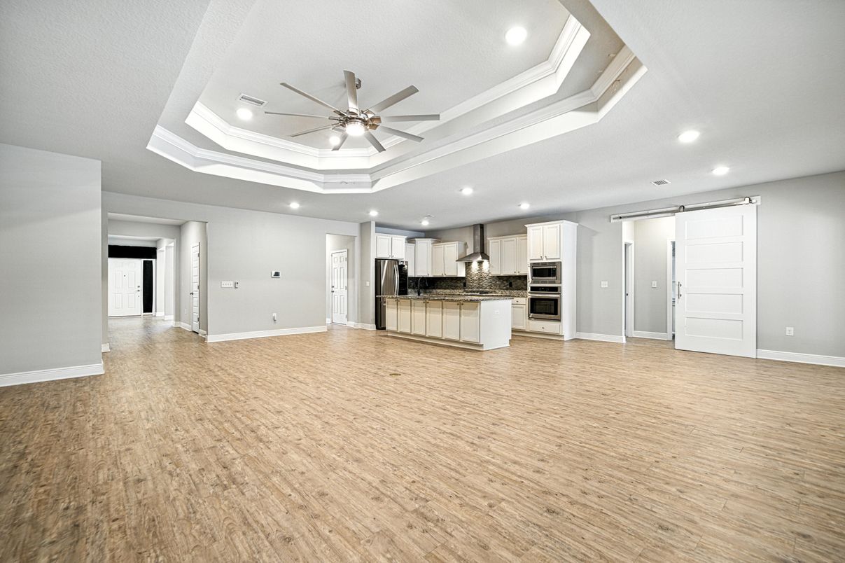 Empty room, Interior, Kitchen, Recessed Lighting, Stainless Steel Appliances, Wood Texture Flooring