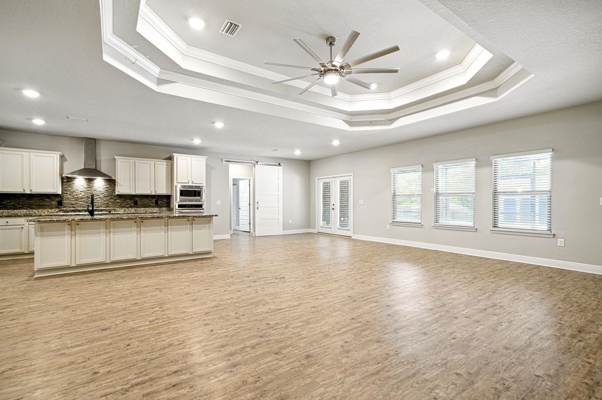 Empty room, Interior, Kitchen, Recessed Lighting, Stainless Steel Appliances, Wood Texture Flooring