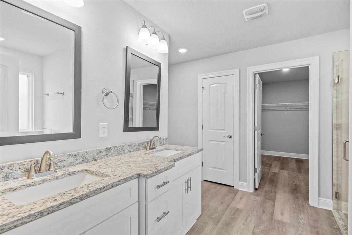 Bathroom, Dual Sink Vanities, Interior, Recessed Lighting, Walk-in Closets, Wood Texture Flooring