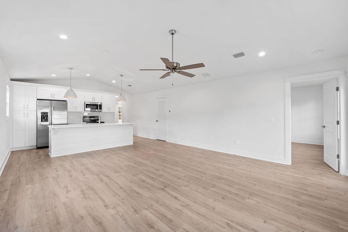 Empty room, Interior, Kitchen, Pendant Lights, Recessed Lighting, Stainless Steel Appliances, Wood Texture Flooring