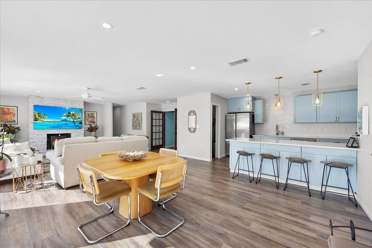 Dining room, Fireplace, Interior, Kitchen, Living room, Pendant Lights, Recessed Lighting, Stainless Steel Appliances, Wood Texture Flooring