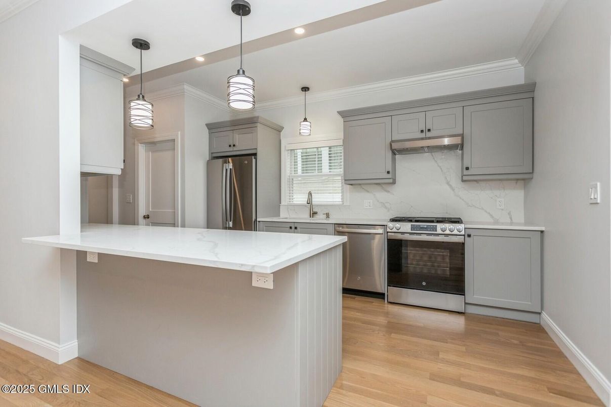 Interior, Kitchen, Marble Walls, Pendant Lights, Recessed Lighting, Stainless Steel Appliances, Wood Texture Flooring