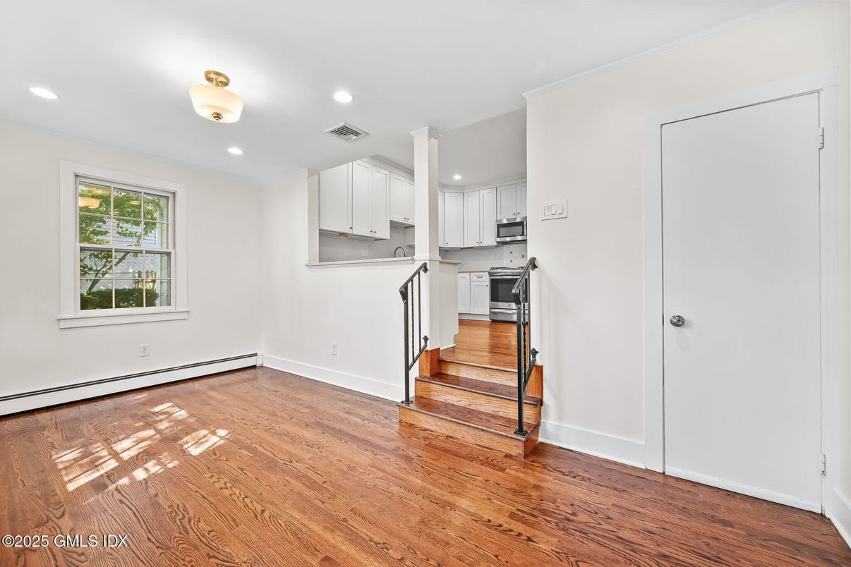 Empty room, Interior, Kitchen, Recessed Lighting, Stainless Steel Appliances, Wood Texture Flooring
