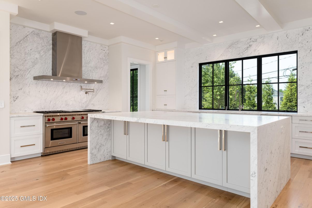 Interior, Kitchen, Marble Walls, Recessed Lighting, Stainless Steel Appliances, Wood Texture Flooring