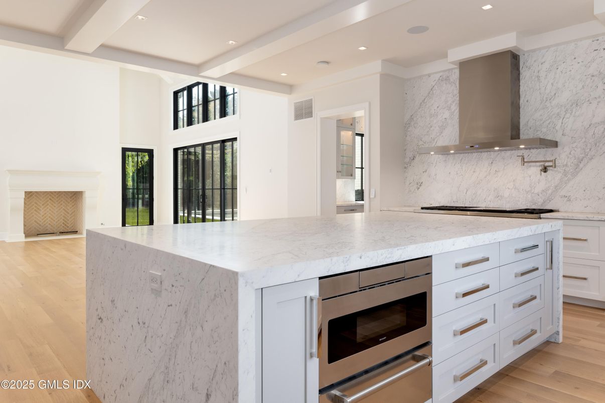 Interior, Kitchen, Marble Walls, Recessed Lighting, Stainless Steel Appliances, Wood Texture Flooring