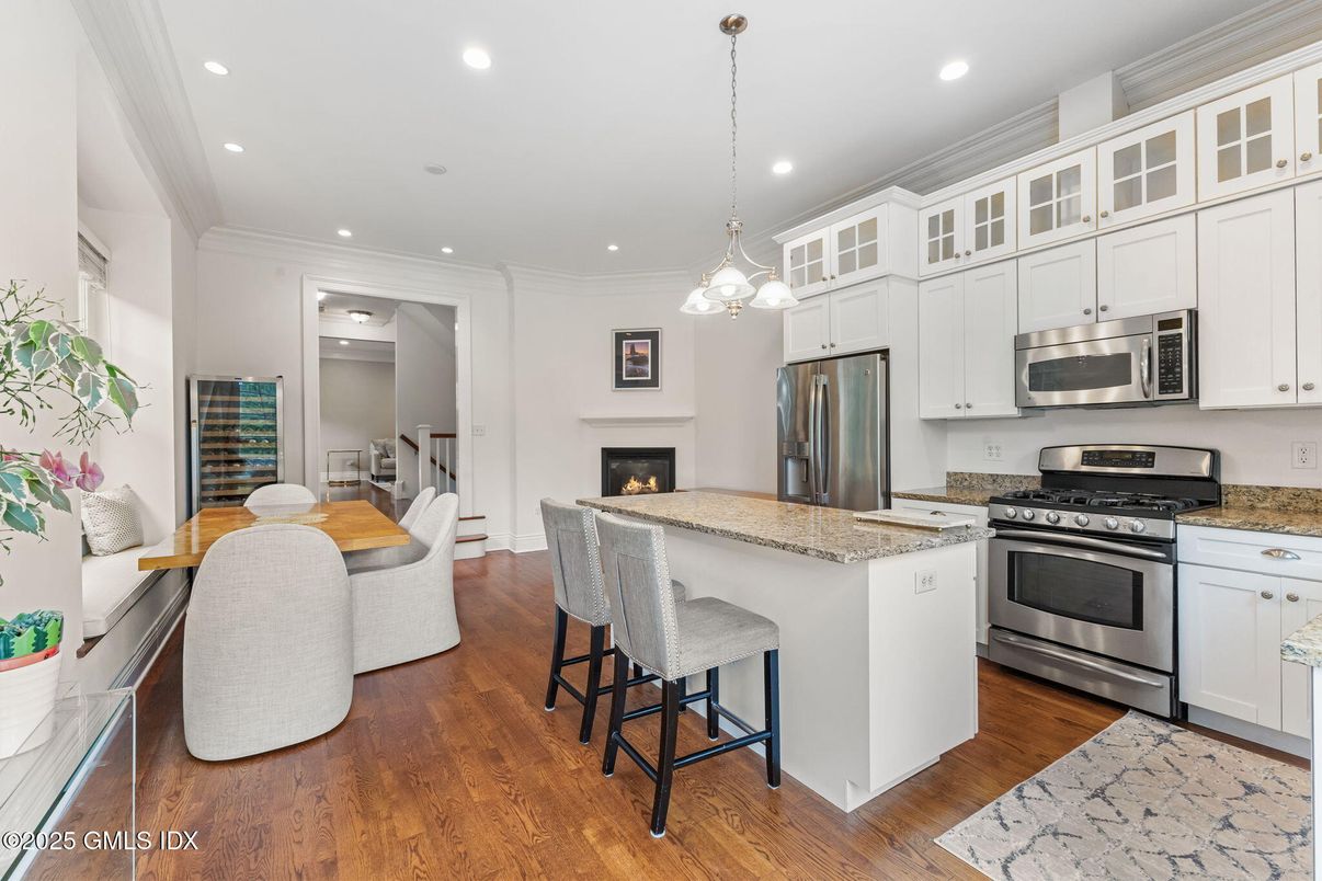 Dining room, Fireplace, Interior, Kitchen, Pendant Lights, Recessed Lighting, Stainless Steel Appliances, Wood Texture Flooring