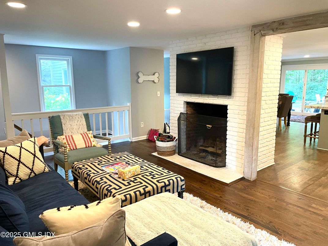 Dining room, Fireplace, Interior, Living room, Recessed Lighting, Stone Walls, Wood Texture Flooring