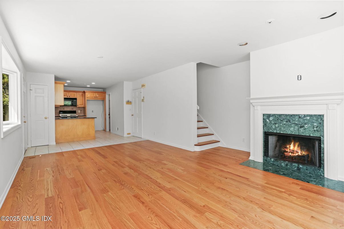 Empty room, Fireplace, Interior, Kitchen, Recessed Lighting, Wood Texture Flooring