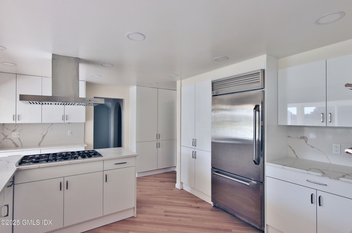 Interior, Kitchen, Marble Walls, Recessed Lighting, Stainless Steel Appliances, Wood Texture Flooring