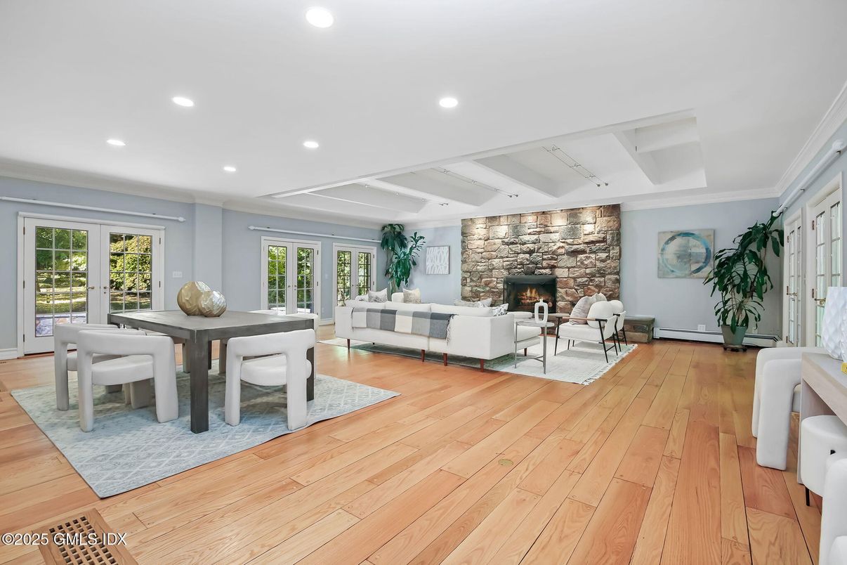 Dining room, Fireplace, Interior, Living room, Recessed Lighting, Stone Walls, Wood Texture Flooring