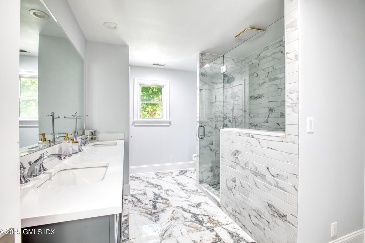 Bathroom, Dual Sink Vanities, Glass Shower, Interior, Marble, Marble Walls, Recessed Lighting