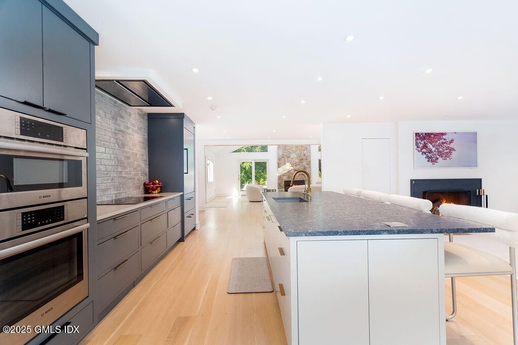 Fireplace, Interior, Kitchen, Recessed Lighting, Stainless Steel Appliances, Wood Texture Flooring