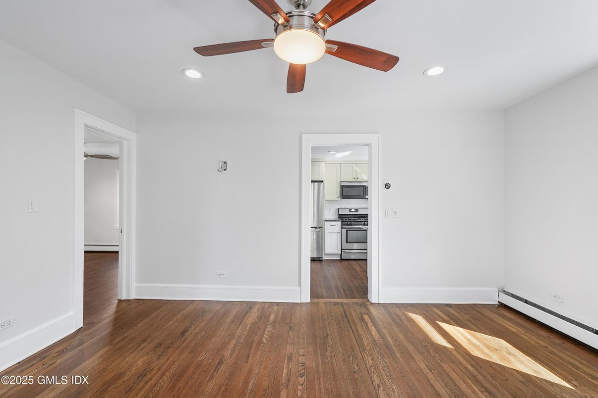 Empty room, Interior, Kitchen, Recessed Lighting, Stainless Steel Appliances, Wood Texture Flooring