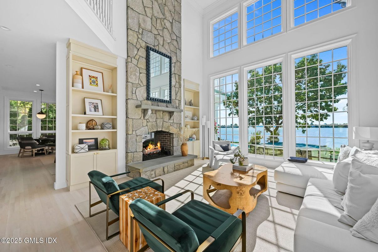 Dining room, Fireplace, Interior, Living room, Pendant Lights, Recessed Lighting, Stone Walls, Water, Wood Texture Flooring