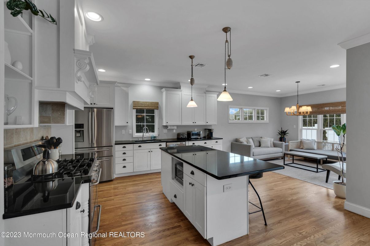 Chandelier, Interior, Kitchen, Living room, Pendant Lights, Recessed Lighting, Stainless Steel Appliances, Wood Texture Flooring