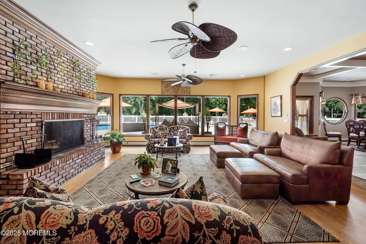 Dining room, Fireplace, Interior, Living room, Recessed Lighting, Stone Walls, Wood Texture Flooring