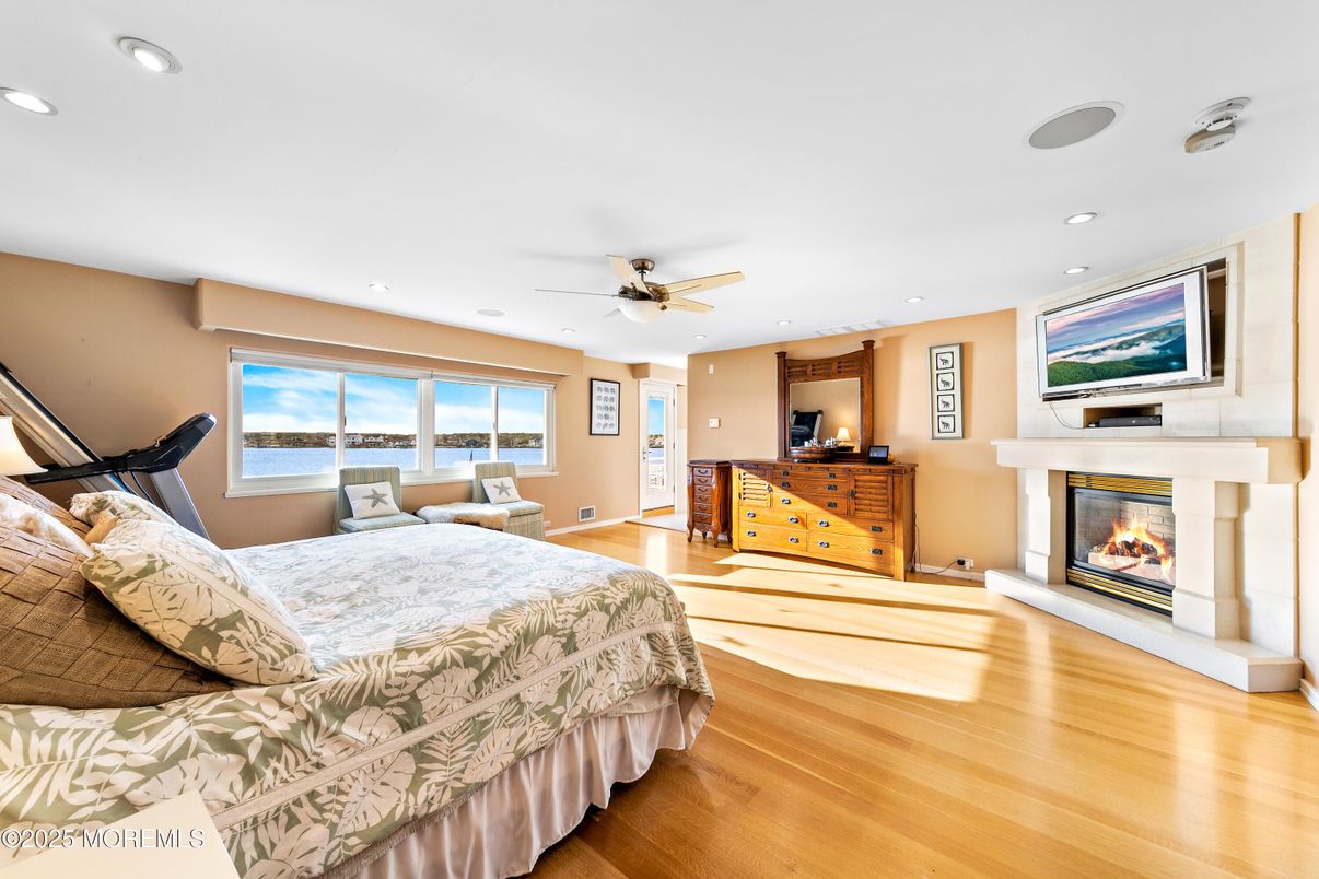 Bedroom, Fireplace, Interior, Recessed Lighting, Water, Wood Texture Flooring