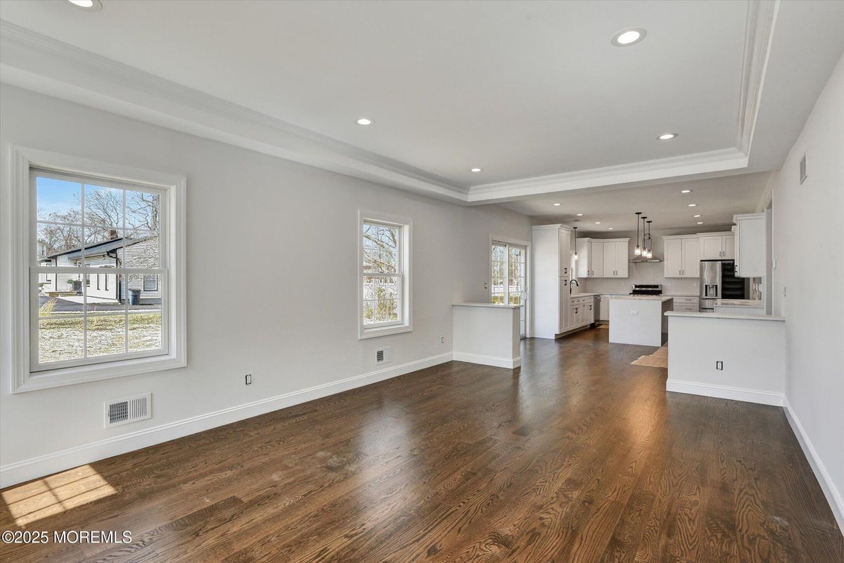 Empty room, Interior, Kitchen, Pendant Lights, Recessed Lighting, Stainless Steel Appliances, Wood Texture Flooring