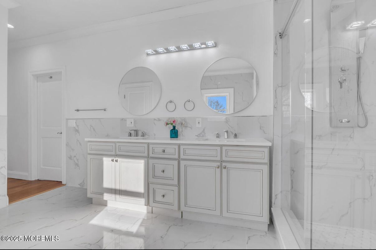 Bathroom, Dual Sink Vanities, Glass Shower, Interior, Marble, Marble Walls, Recessed Lighting