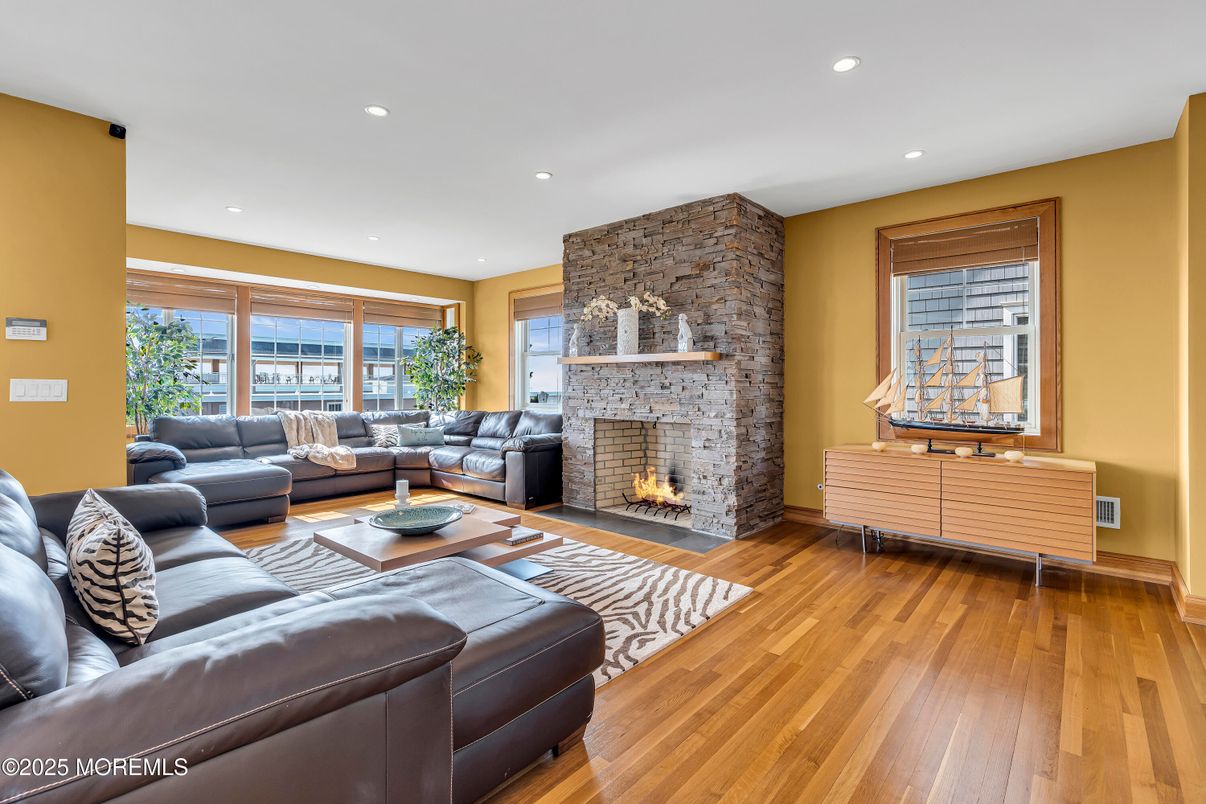 Fireplace, Interior, Living room, Recessed Lighting, Stone Walls, Wood Texture Flooring