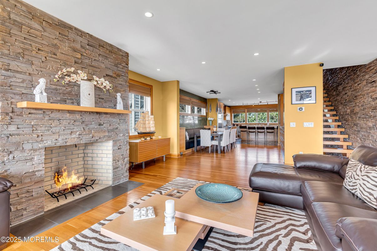 Dining room, Fireplace, Interior, Living room, Recessed Lighting, Stone Walls, Wood Texture Flooring