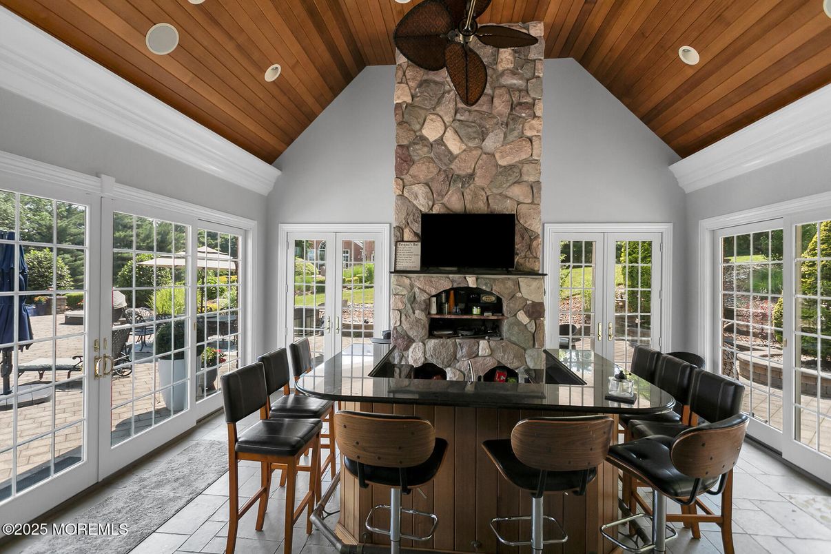 Dining room, Fireplace, Interior, Recessed Lighting, Stone Walls, Wooden Ceilings