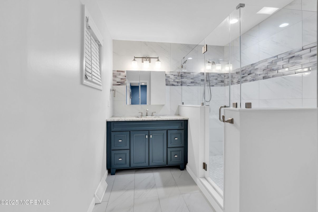 Bathroom, Dual Sink Vanities, Glass Shower, Interior, Marble, Marble Walls, Recessed Lighting