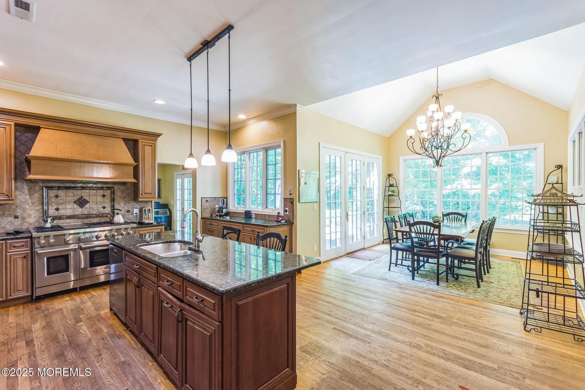 Chandelier, Dining room, Interior, Kitchen, Pendant Lights, Recessed Lighting, Stainless Steel Appliances, Wood Texture Flooring