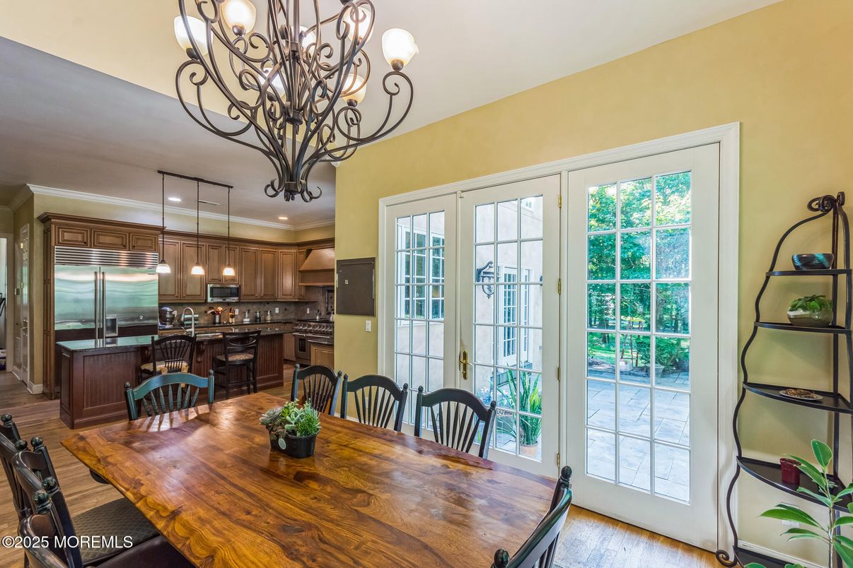 Chandelier, Dining room, Interior, Kitchen, Pendant Lights, Recessed Lighting, Stainless Steel Appliances, Wood Texture Flooring