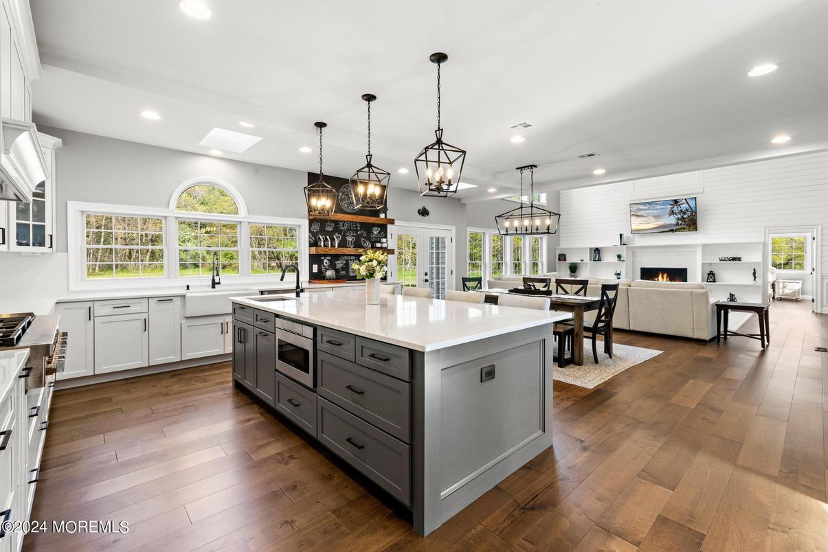 Chandelier, Dining room, Fireplace, Interior, Kitchen, Living room, Pendant Lights, Recessed Lighting, Stainless Steel Appliances, Wood Texture Flooring
