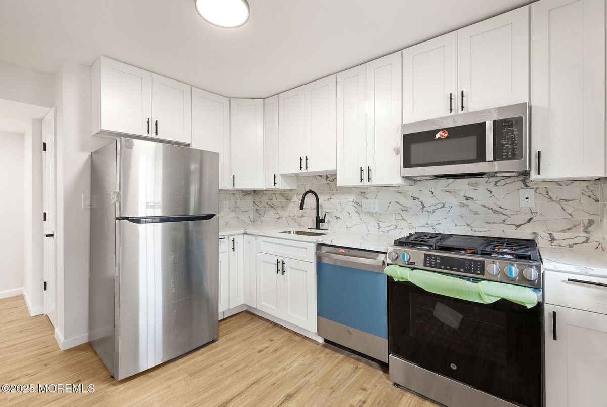 Interior, Kitchen, Marble Walls, Recessed Lighting, Stainless Steel Appliances, Wood Texture Flooring