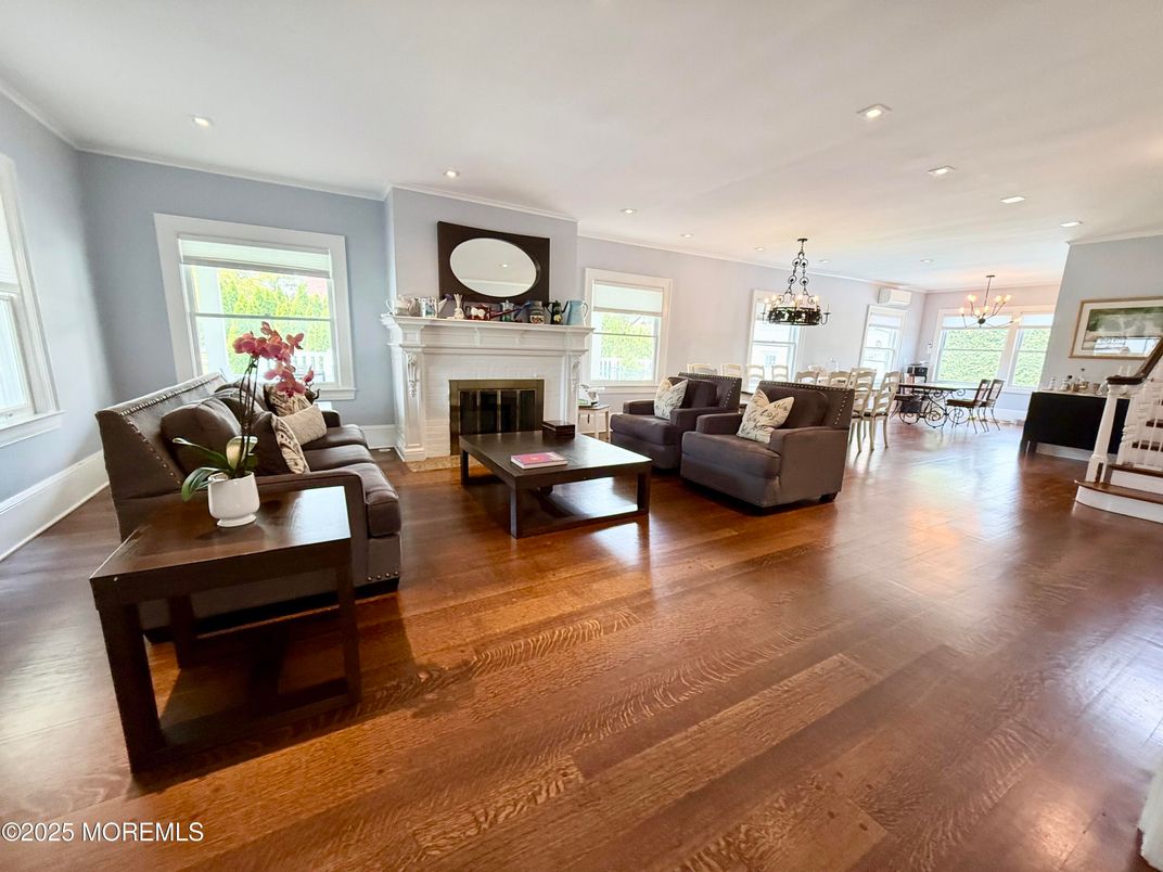Chandelier, Dining room, Fireplace, Interior, Living room, Pendant Lights, Recessed Lighting, Wood Texture Flooring
