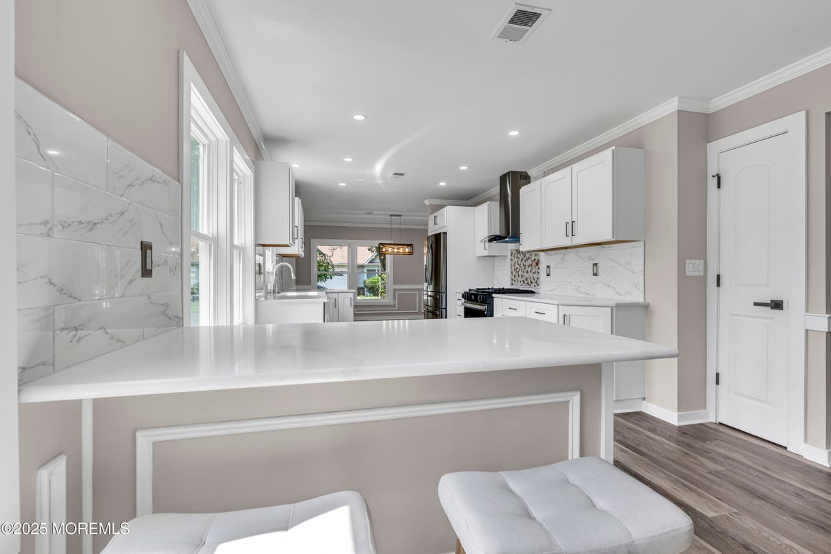 Interior, Kitchen, Marble Walls, Pendant Lights, Recessed Lighting, Stainless Steel Appliances, Wood Texture Flooring