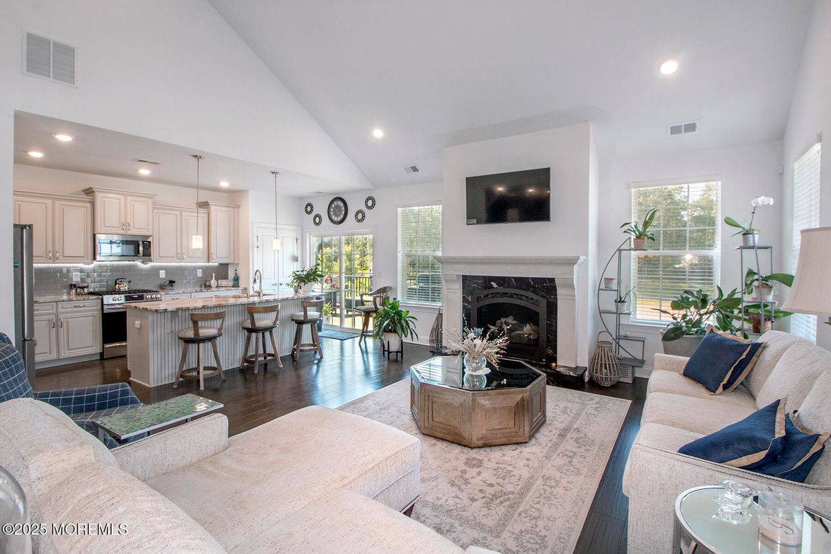 Fireplace, Interior, Kitchen, Living room, Pendant Lights, Recessed Lighting, Stainless Steel Appliances, Wood Texture Flooring